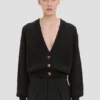 Cardigan con tasche a trecce in nero Cardigan con tasche a trecce in nero