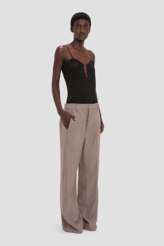 Pantaloni con vita plissettata in color calcare